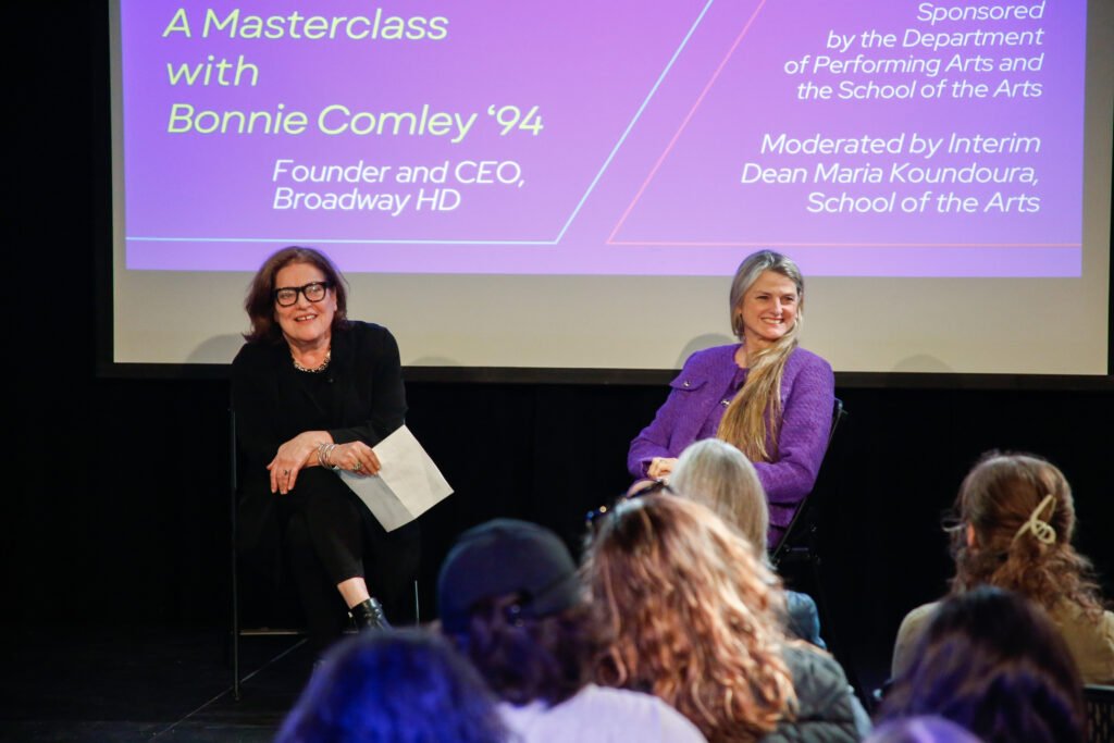 Maria Koundoura and Bonnie Conley smile while sitting on stage during the masterclass