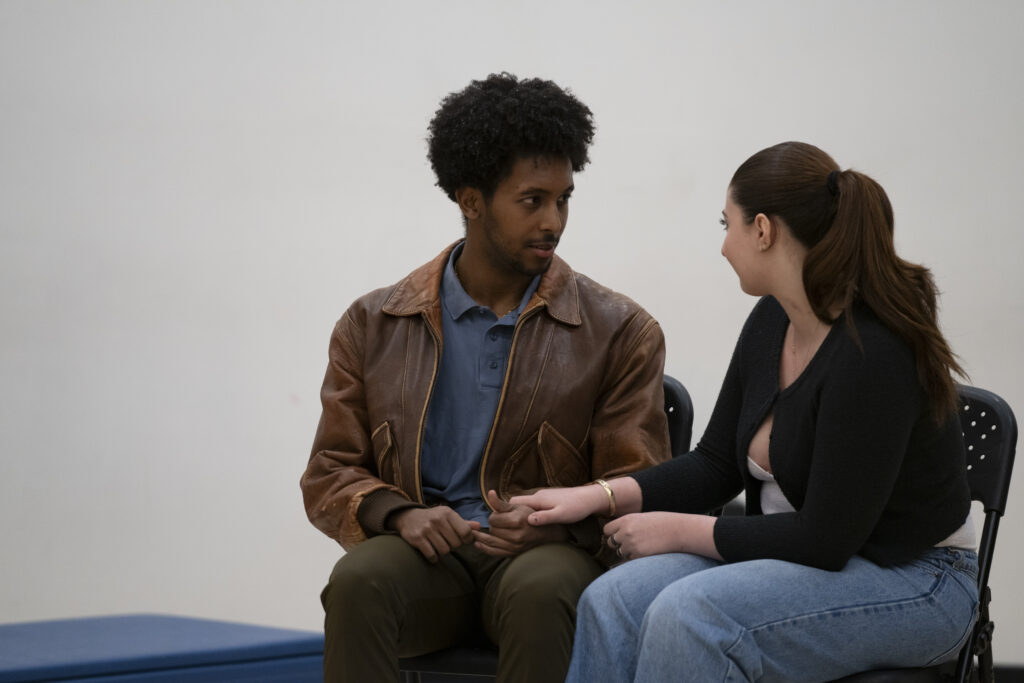 Two students sit while performing a scene during the master class