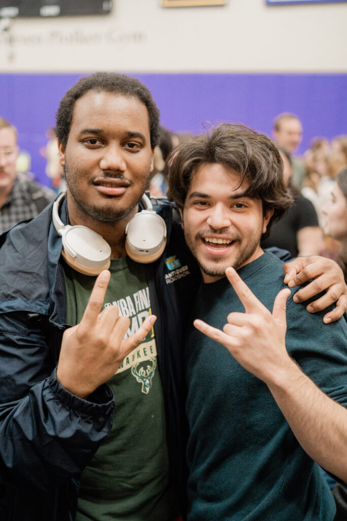 Two people give the shaka symbol