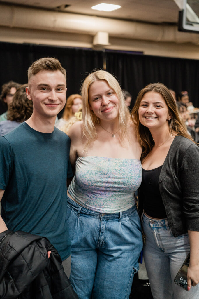Three people look at the camera