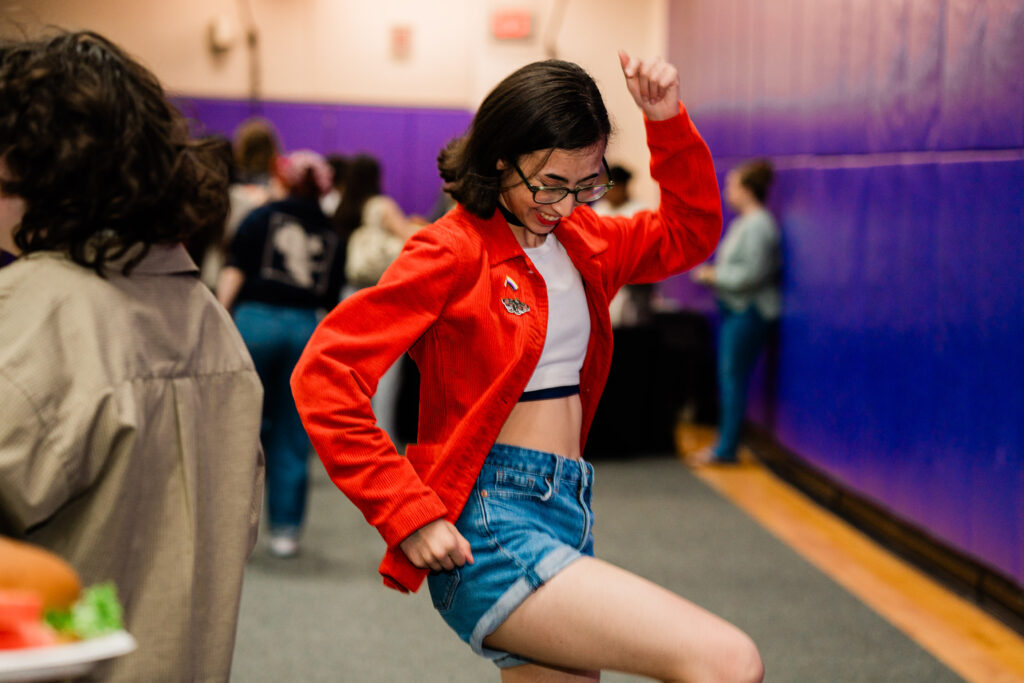 One person joyfully does a dance move