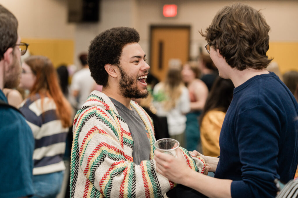 One person smiles while talking to someone