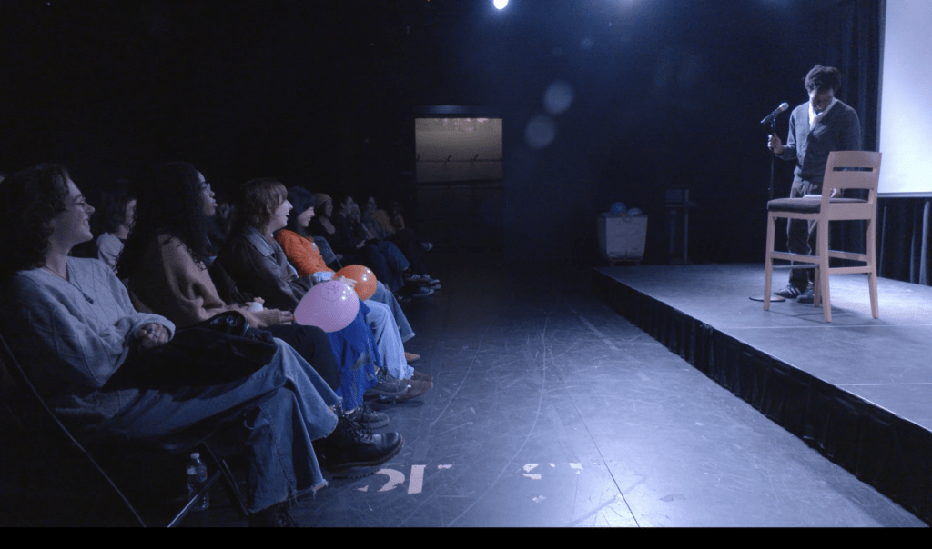 Elijah Groves performs standup comedy on stage