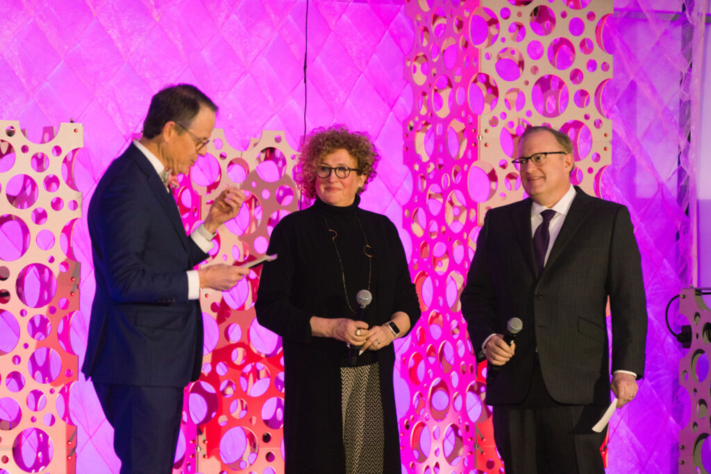 Tim Ritchie, Sharon Topper and Jay Bernhardt stand on stage together