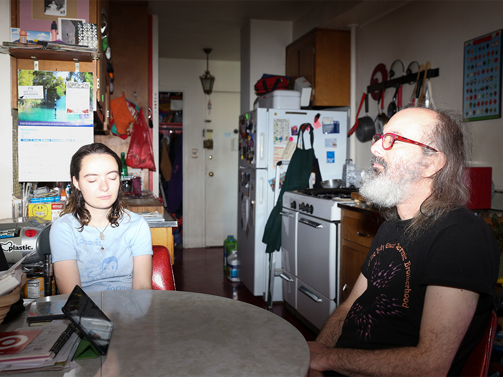 Illona Grollman sits at a table with her father