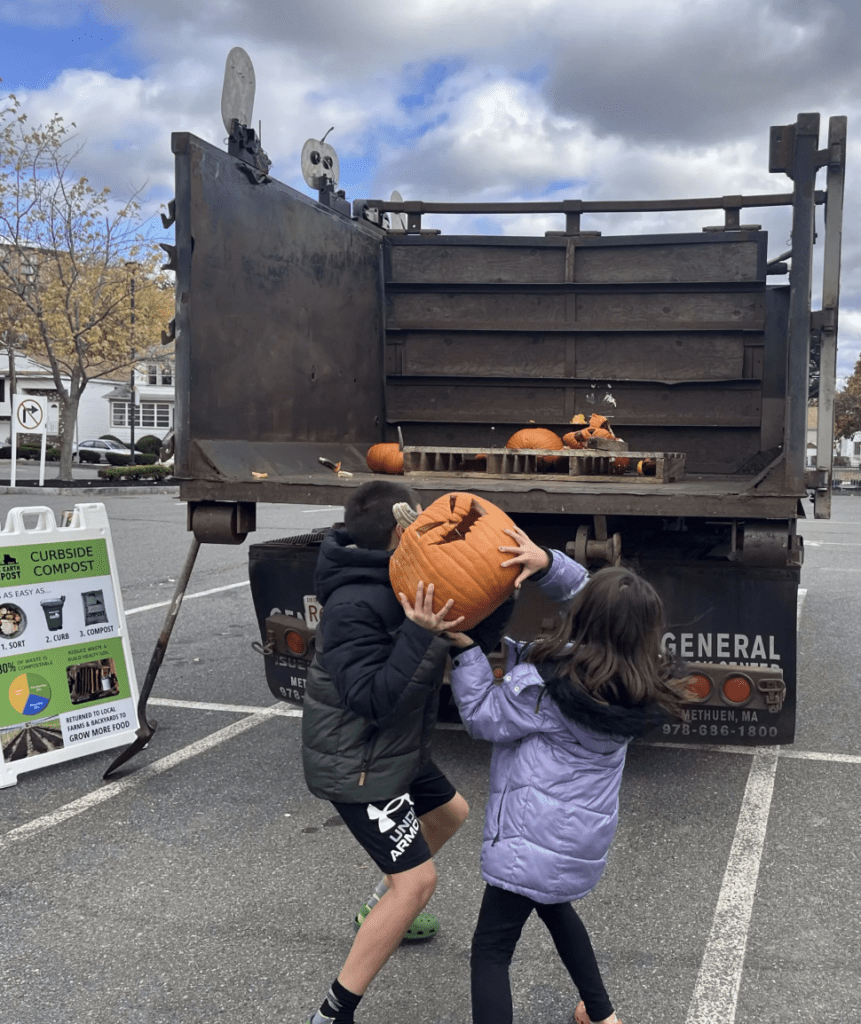Kids toss a pumpkin into a truck