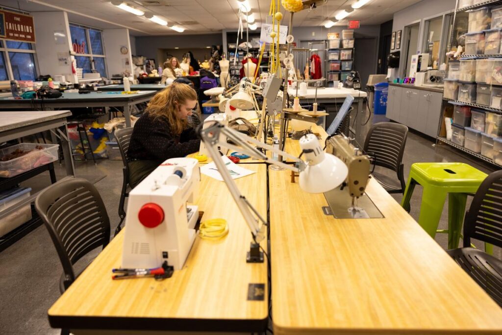 A student works at a sewing machine