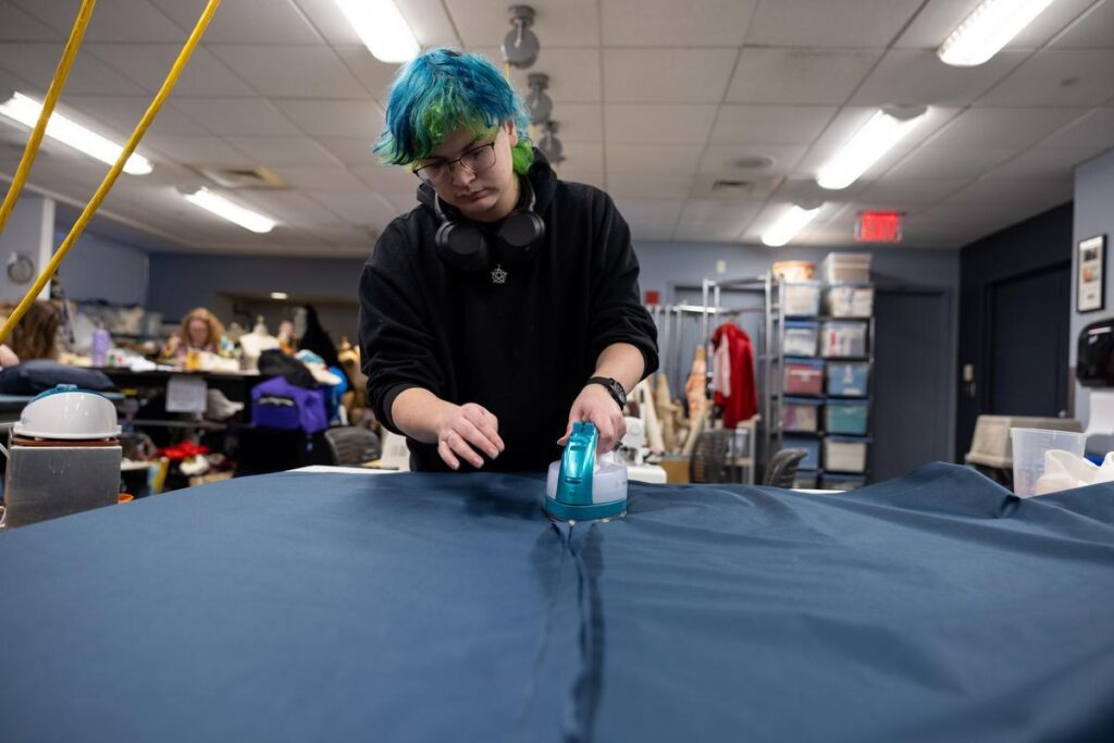 A person irons fabric