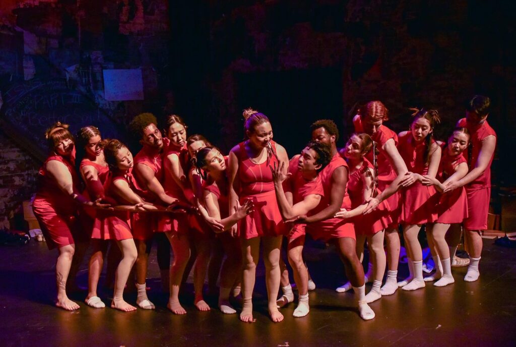 Members of the cast are wearing red dresses