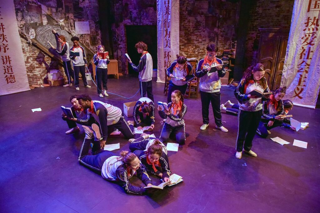 A bunch of actors are on stage performing