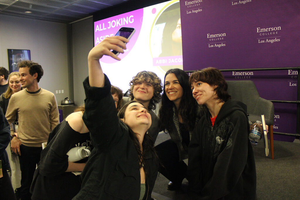 Abbi Jacobson poses for a selfie with three students