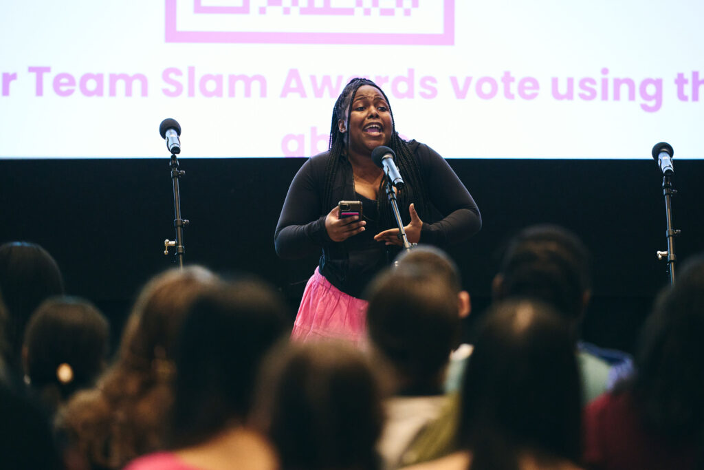 A person performs in front of a microphone
