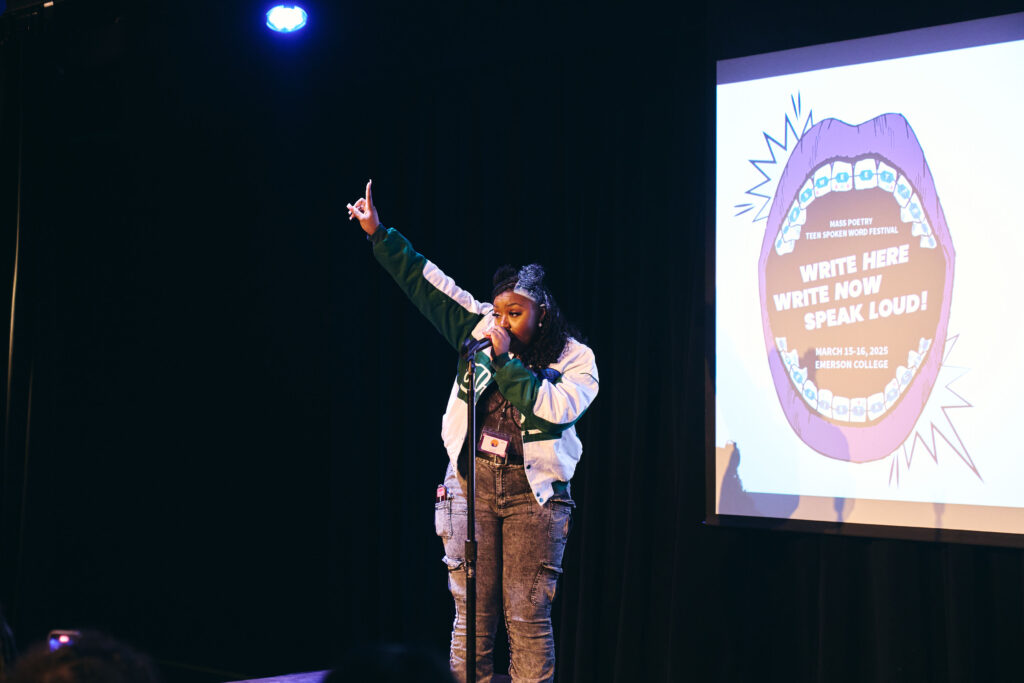A performer raises one finger in the air