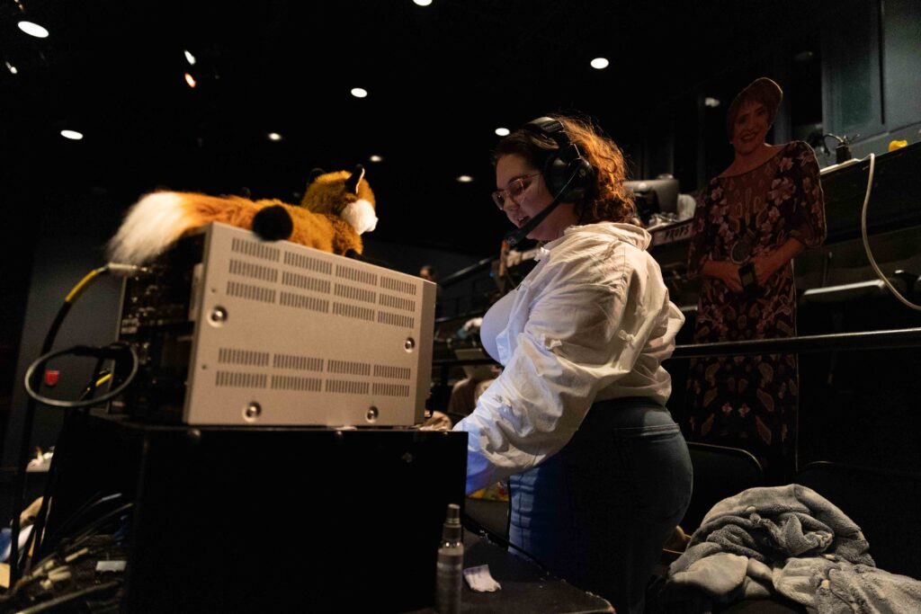 Stage Manager Elizabeth Tippen '26 does the final preparations before a full run-through of the play. 
