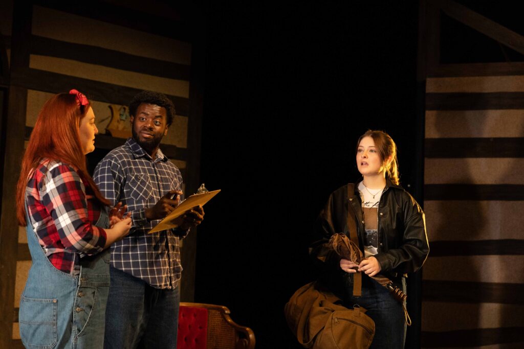 Three actors perform during a dress rehearsal