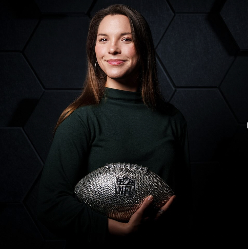 Kate Foulz holds a silver football