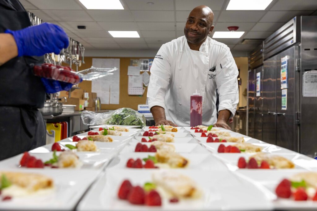 Chef Alex Drumm oversees desserts being made in the kitchen