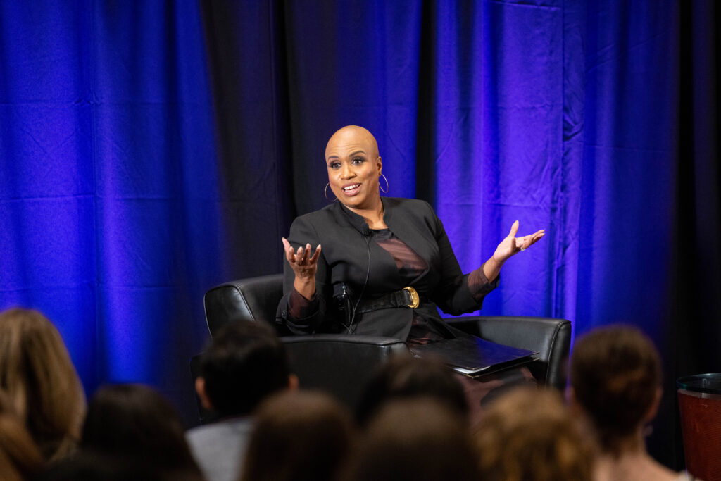 Ayanna Pressley sits and speaks and has her hands up
