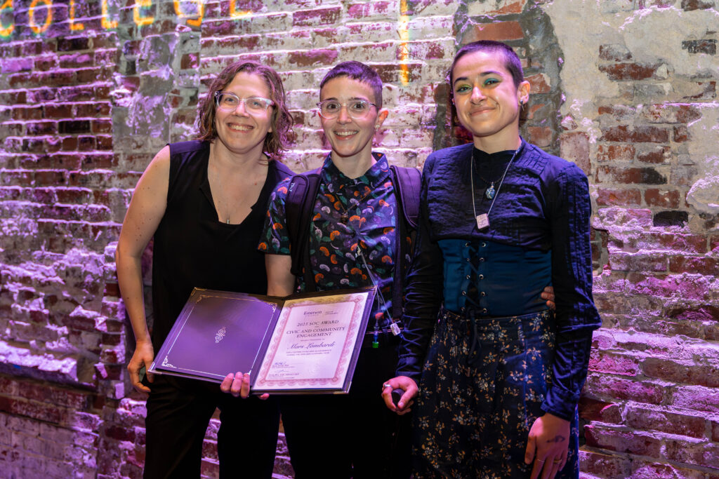 Award and their family smile for a photo.
