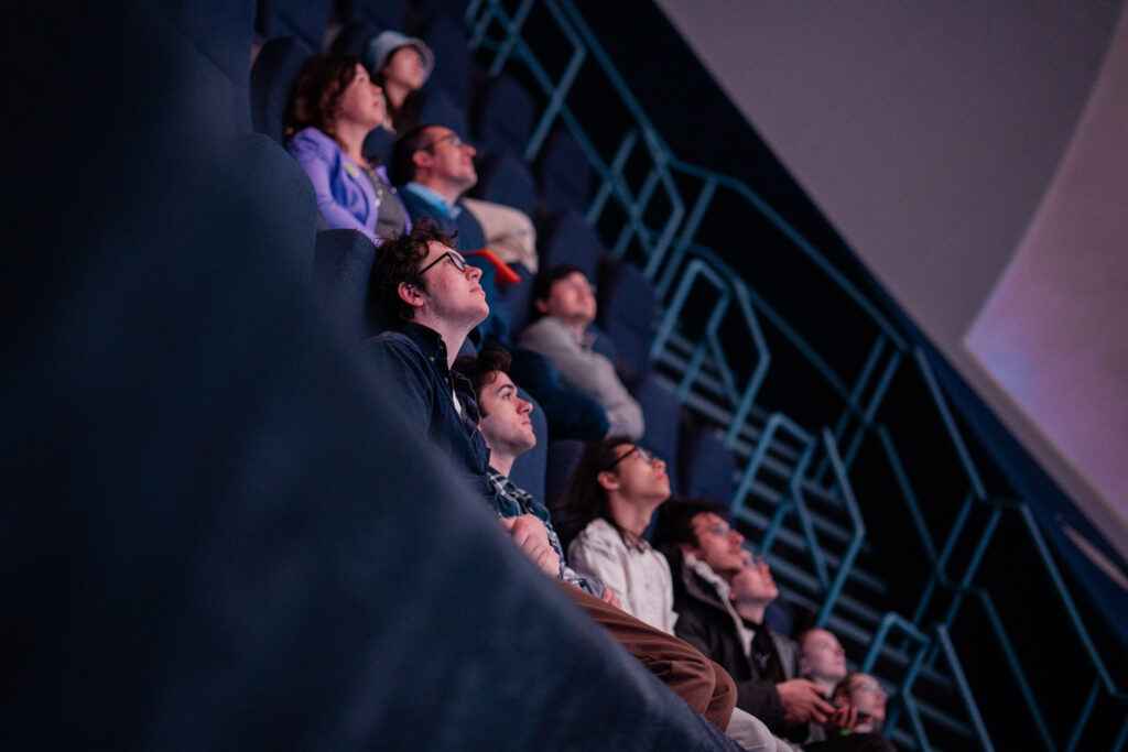 Students look up at the IMAX screen