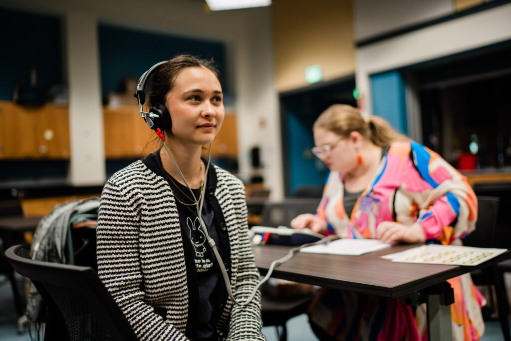 A person gets their hearing tested while wearing earphones