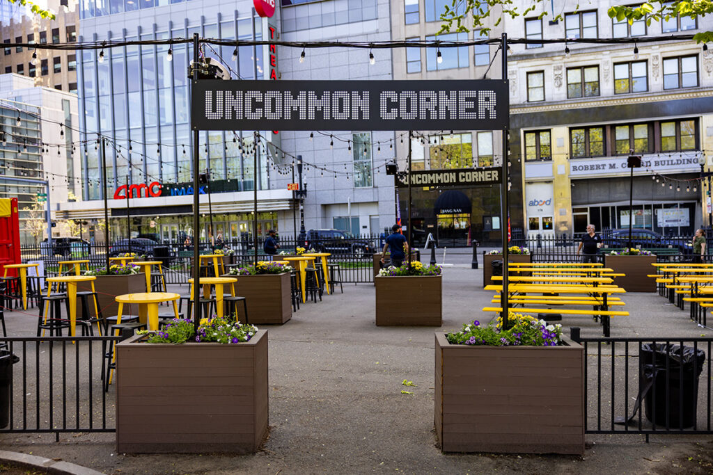 Sign reading Uncommon Corner with leading to tables and stools