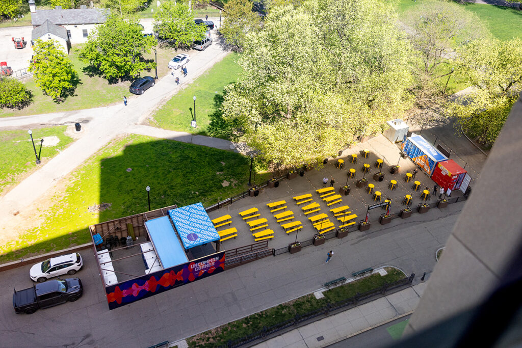 Aerial view showing stage, picnic tables, high top tables, beer and food trucks