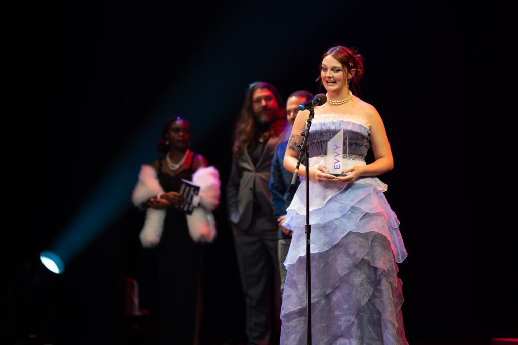 Woman accepts award on stage