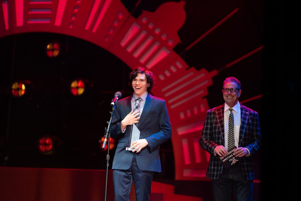 Person accepting award on stage