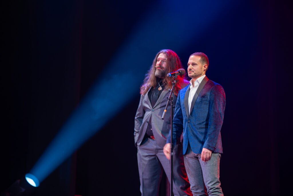 Two award presenters on stage