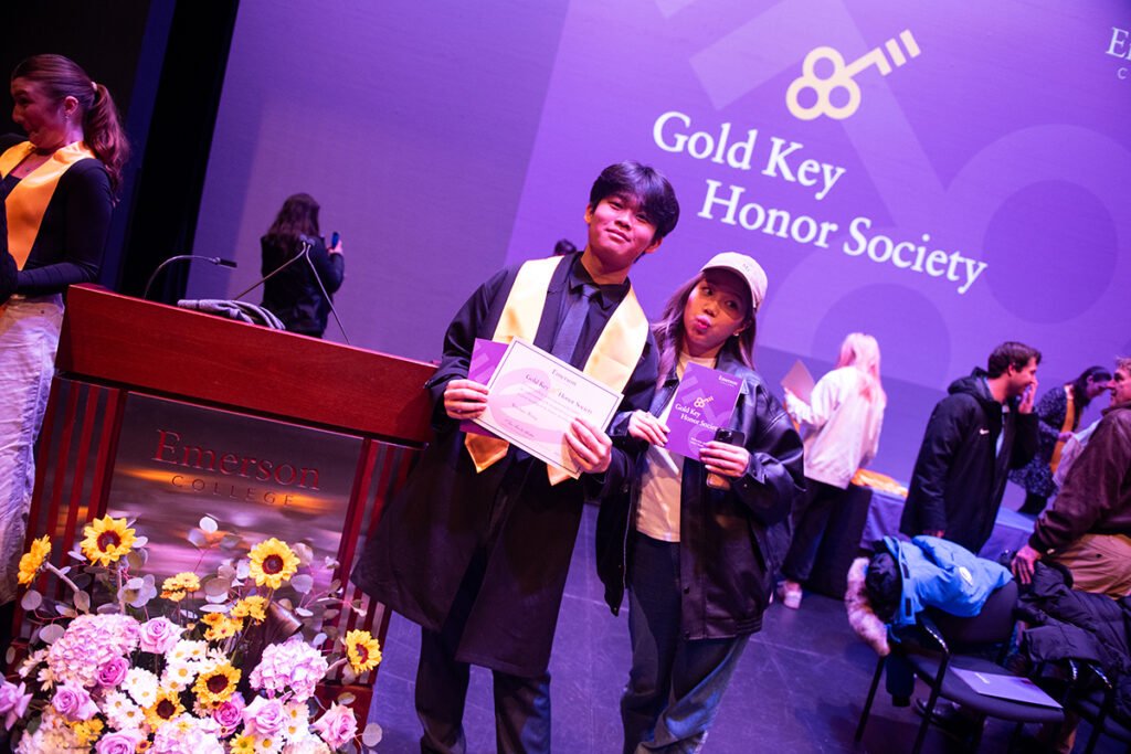 Student holding certificate.