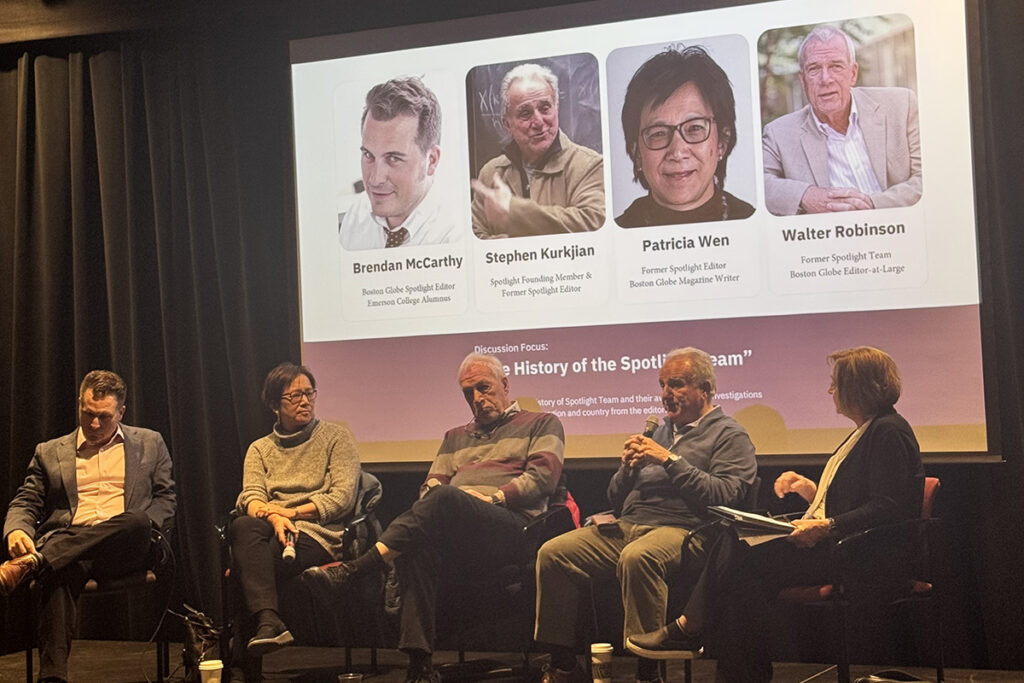 five people sit in chairs in front of screen showing four headshots