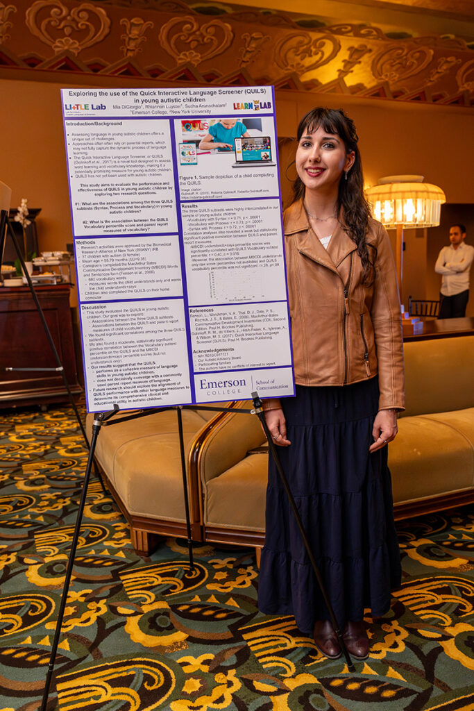 Woman stands next to poster board on easel