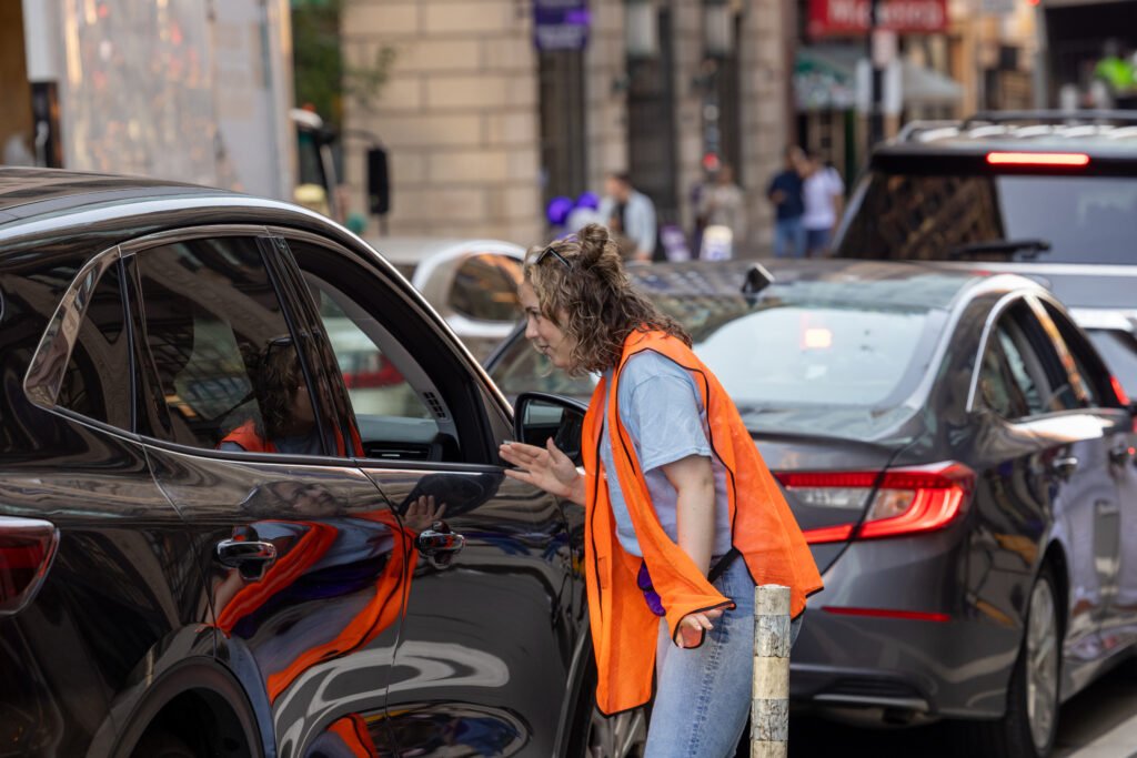 Orientation leader talking to cars