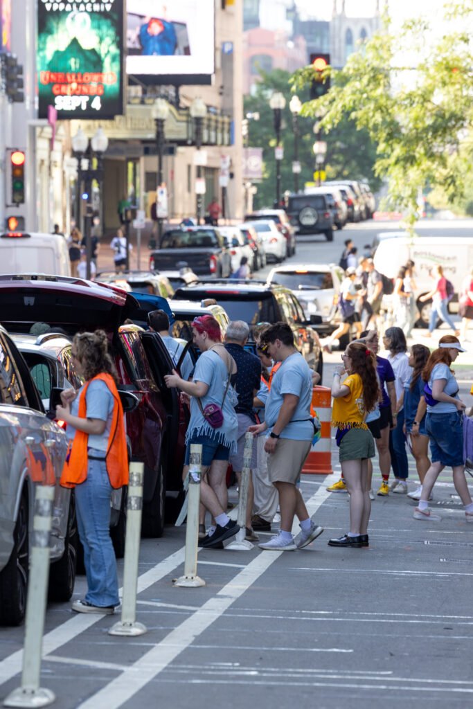 Orientation leaders helping cars