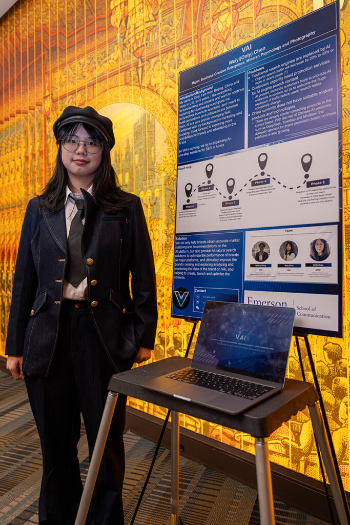 woman stands next to poster board on easel