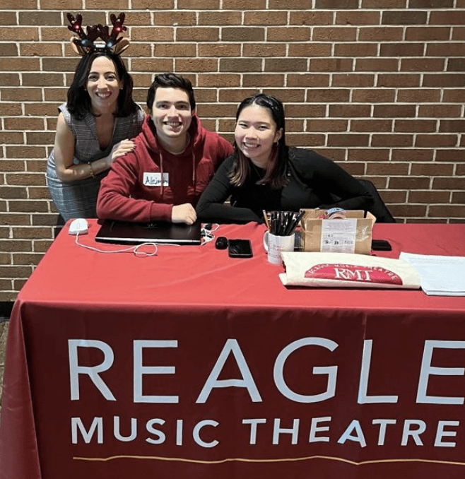 Students and director at the Reagle Music Theatre table.