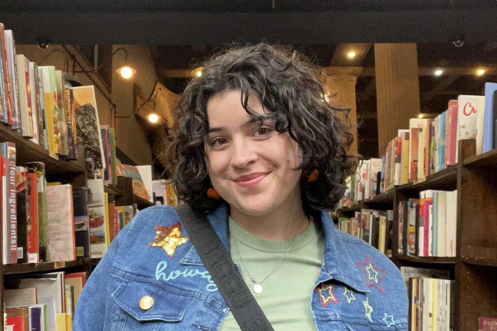 Sofia Attaway-Jimenez between bookshelves