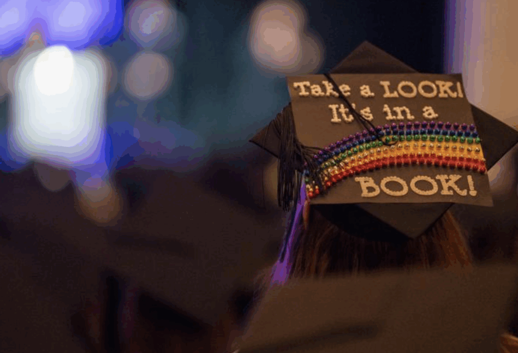 a mortar board that says take a look at a book