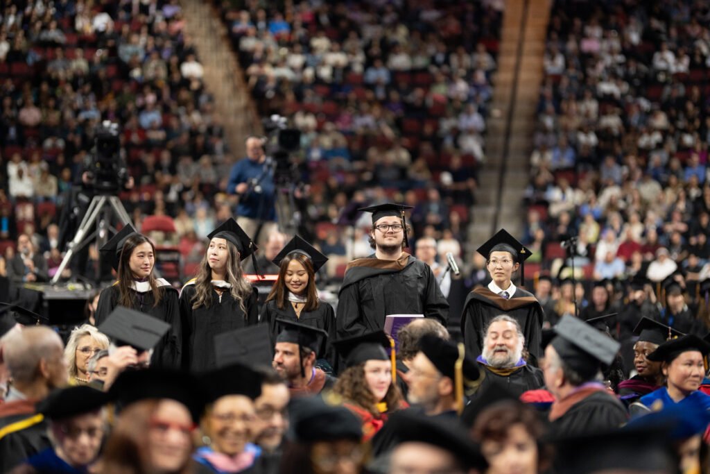 Several students stand up in the back row