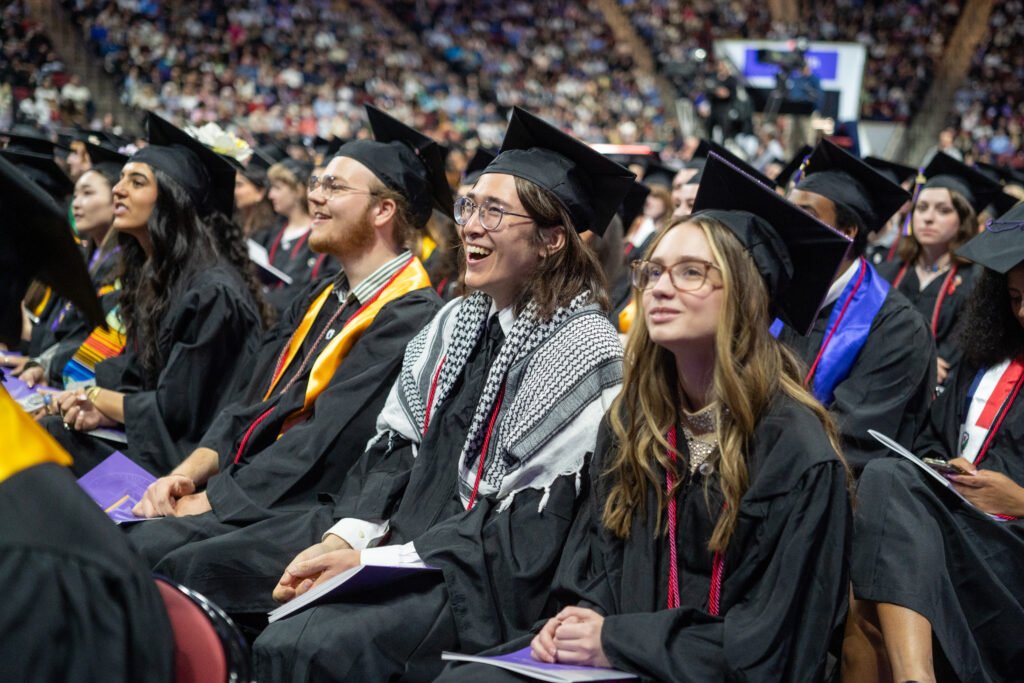 Students sit and listen to speakers