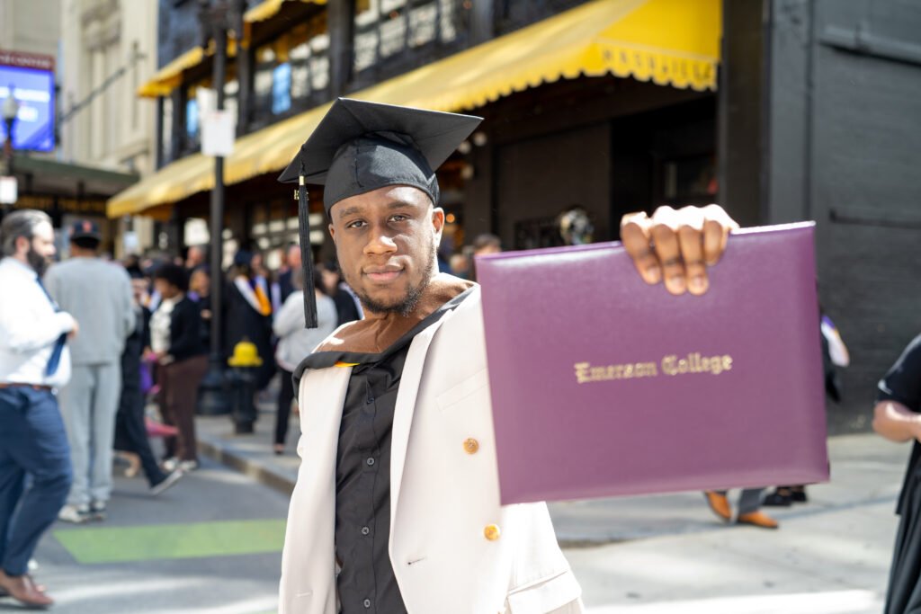 Grad poses with diploma.