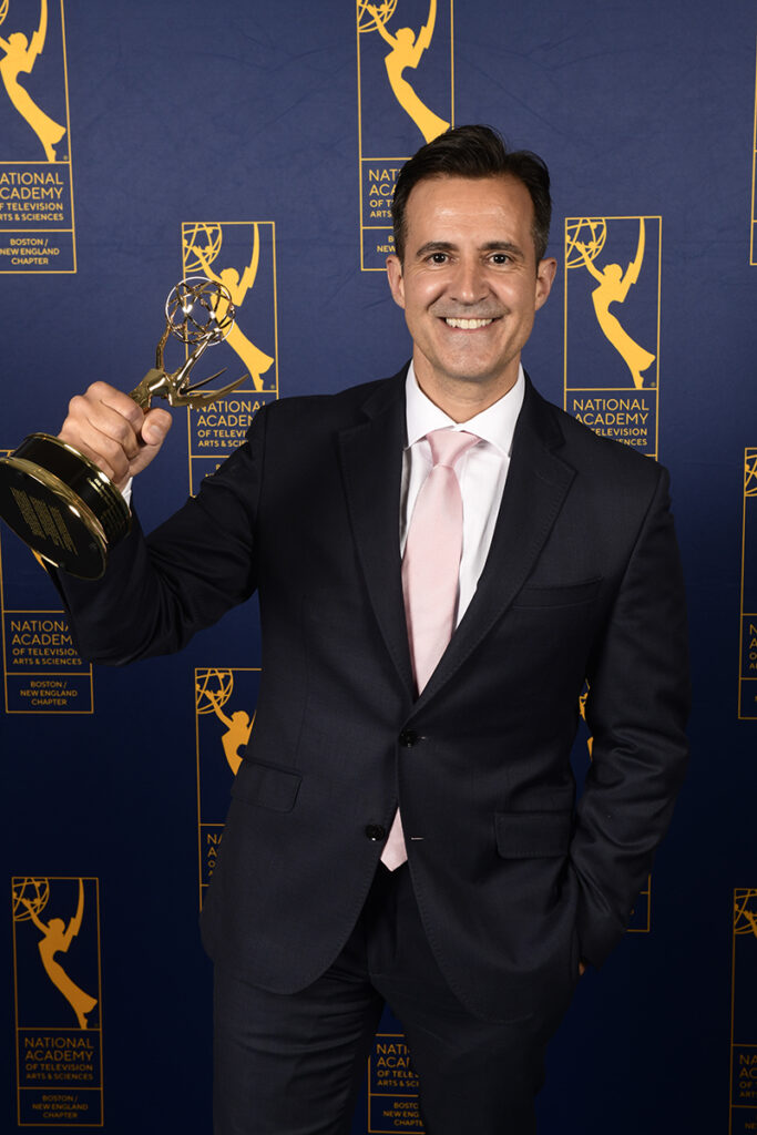David Wade holding Emmy Award