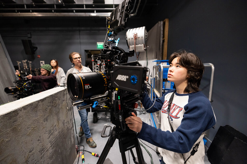 student looks through video camera