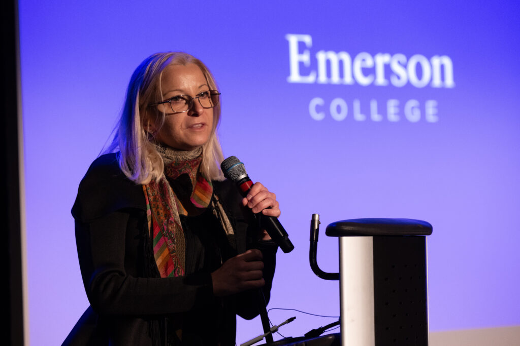 Roxana Maiorescu speaks holding a microphone