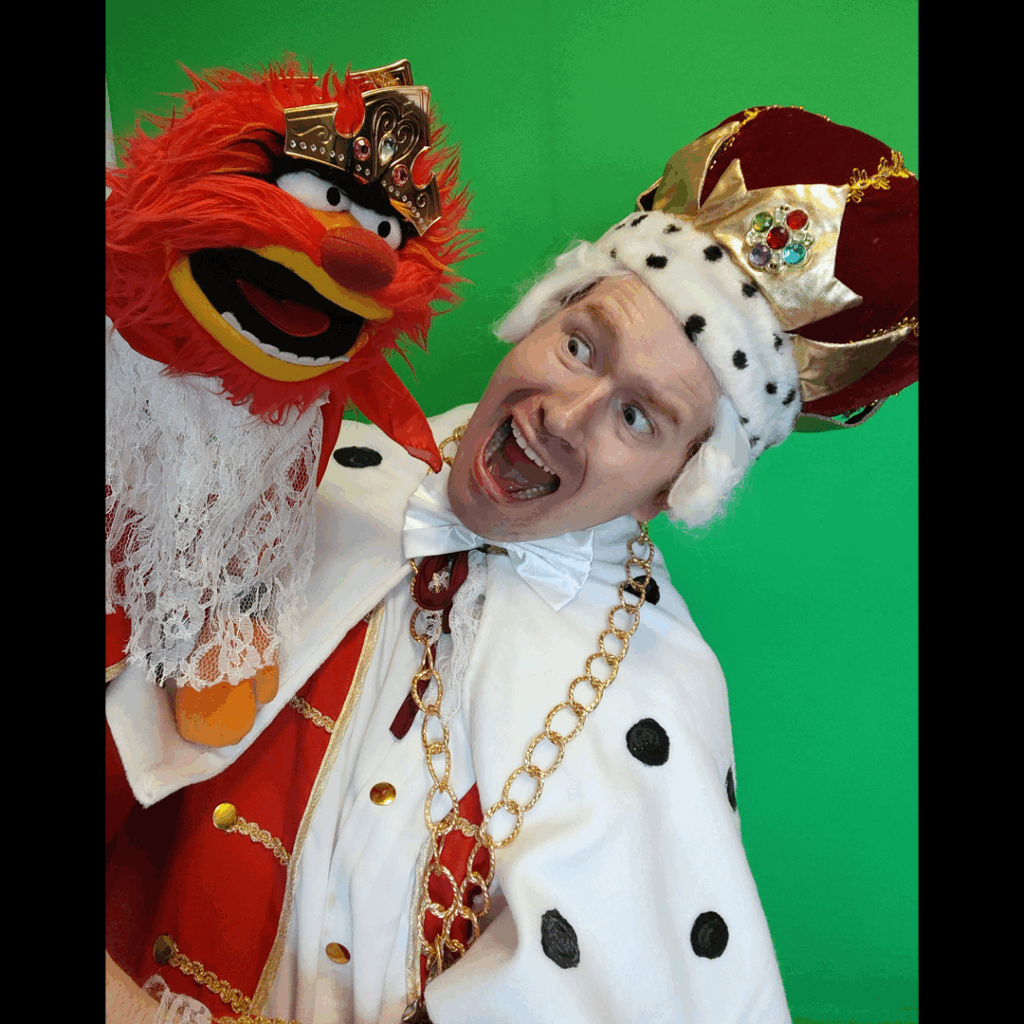 Ricky Downes III dressed as King George while holding a puppet of Animal from the Muppets