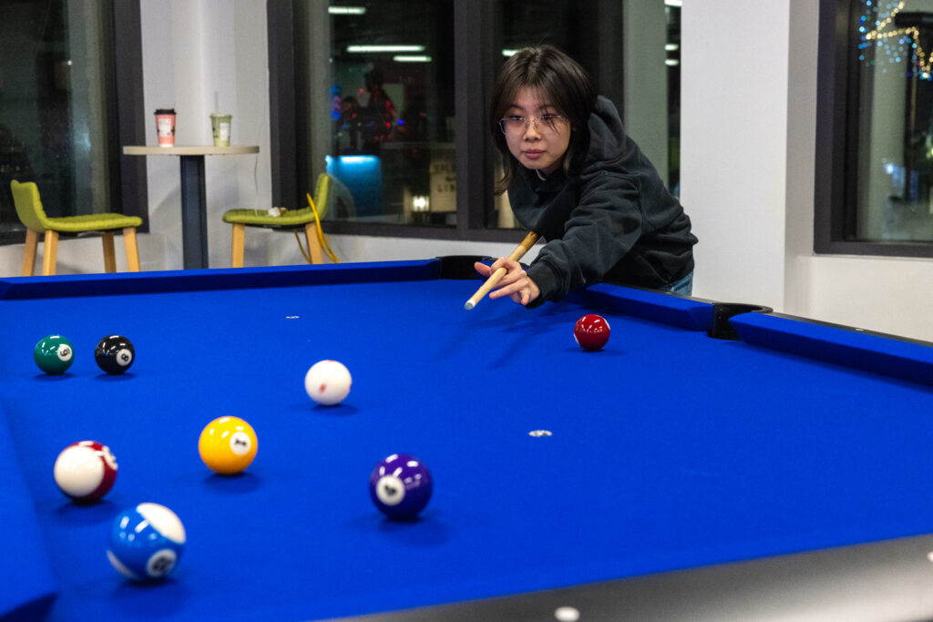 A person plays pool