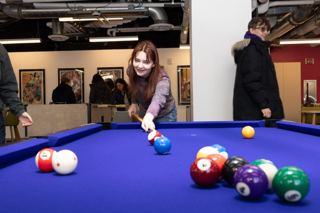 A person plays pool