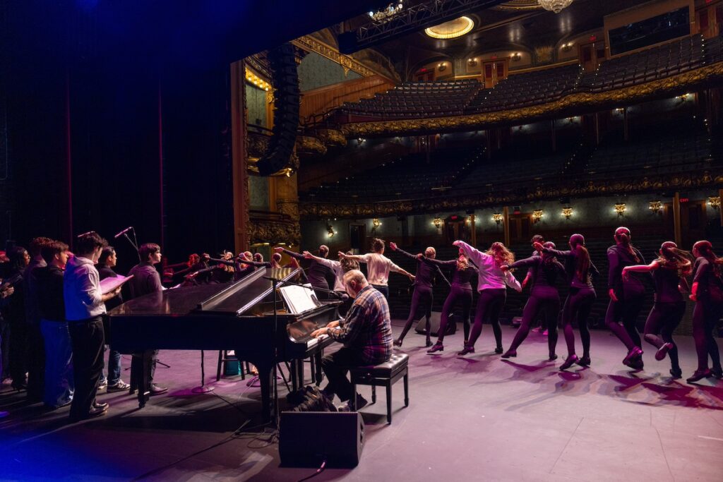 Photo of musical theatre students rehearsing before their performance with actress Sutton Foster