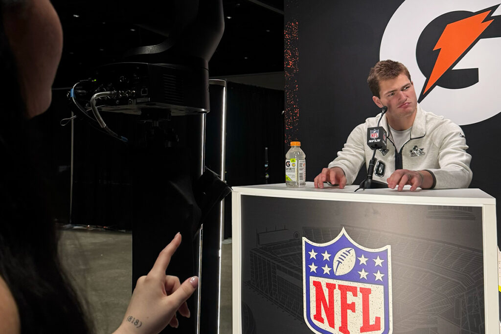 Patriots QB Drake Maye contemplates a question as an Emerson student films during a pre-Super Bowl press conference